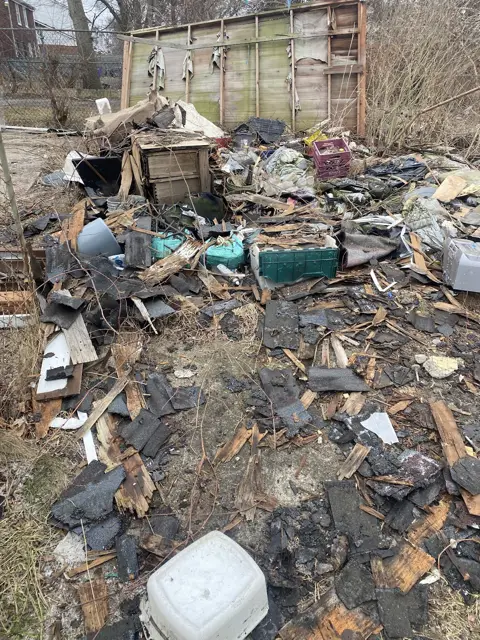 Yard full of debris, before