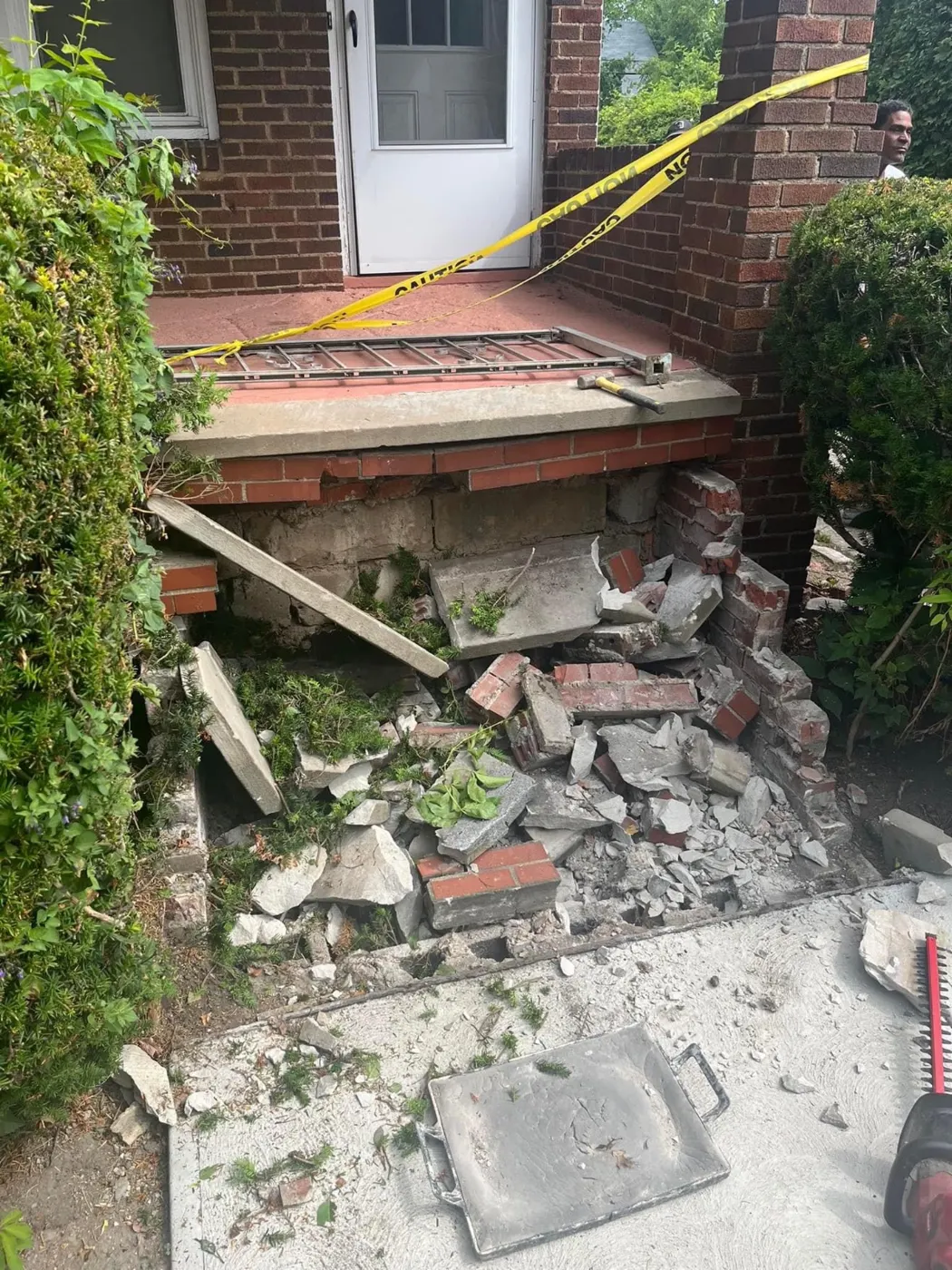Crumbling brick porch steps before demolition